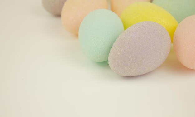 Multicolored decorative eggs on a white background Happy Easter Place for text Festive background