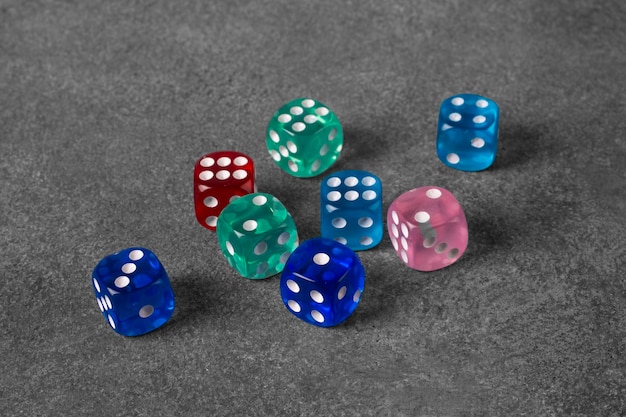 Multicolored dice on a concrete background