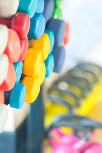 Multicolored dumbbells on a blurred background