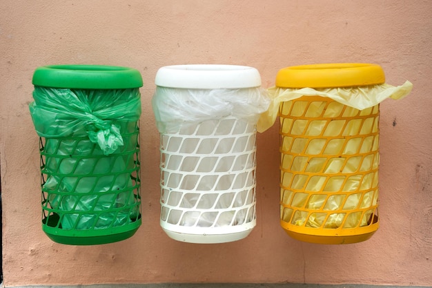 multicolored dustbins for rubbish paper glass Plastic metall in the street