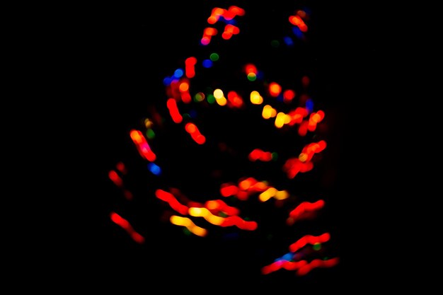 Multicolored dynamic curving light trails Blurred lights trails making pattern on background