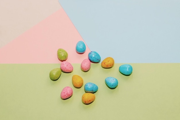 Multicolored Easter decorative eggs on a pastel background