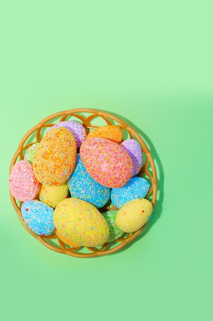 Multicolored Easter decorative eggs on a pastel background