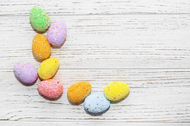 Multicolored Easter decorative eggs on a pastel background