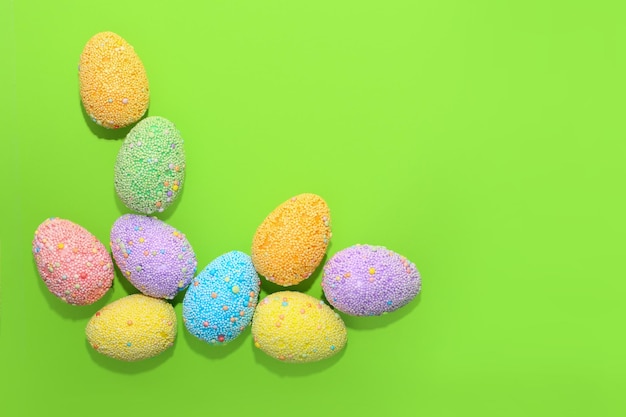 Multicolored Easter decorative eggs on a pastel background