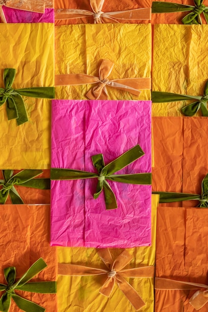 Photo multicolored envelopes decorated with ribbons and bows stacked together