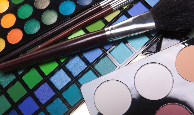 Multicolored eye shadows with cosmetics brush