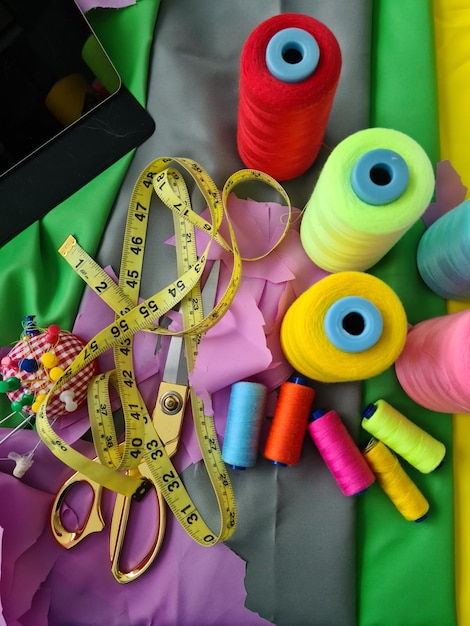 Multicolored fabric threads and scissors in atelier closeup