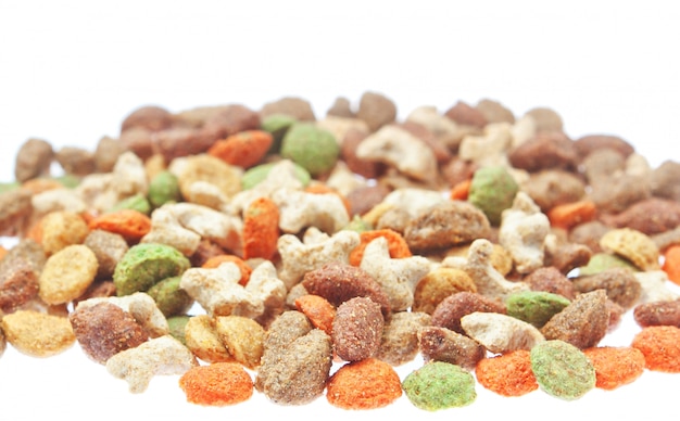 Multicolored food for cats and dogs. On a white wall.