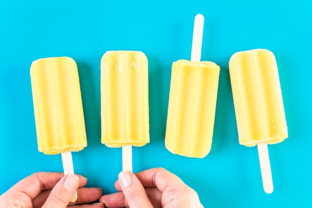 Multicolored fruit ice cream bars on colored background