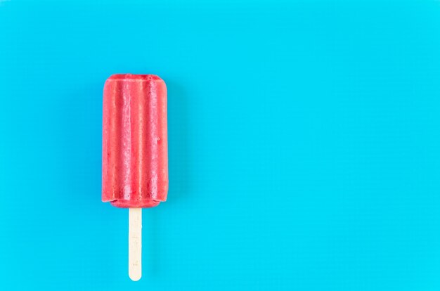 Multicolored fruit ice cream bars on colored background.