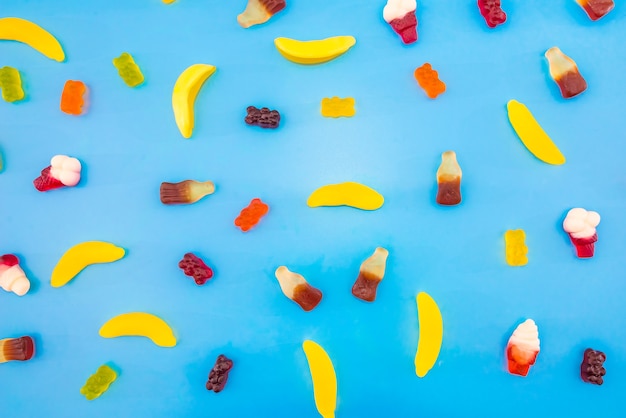 Multicolored jelly candies on a blue background