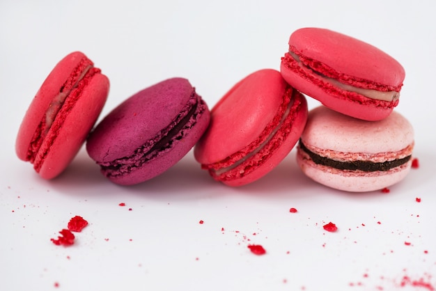 Multicolored macaroons on a white table.