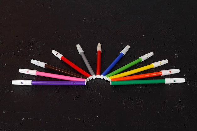 Multicolored markers for drawing Markers on a black isolated background