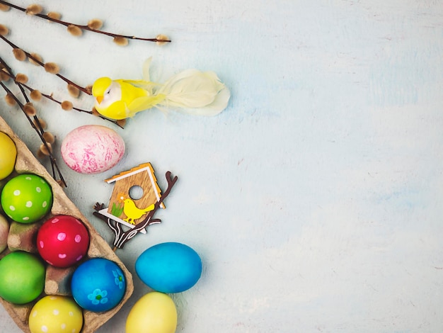 Multicolored painted eggs on a blue background The concept of Easter Place for text