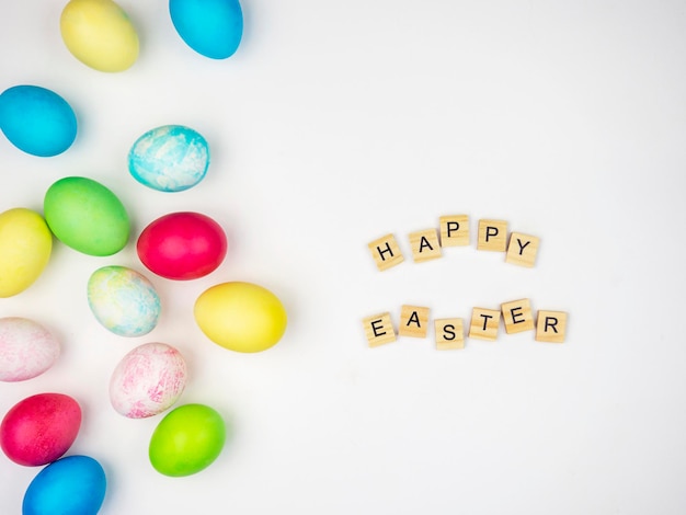 Multicolored painted eggs on a white background with the inscription Happy Easter Easter Concept