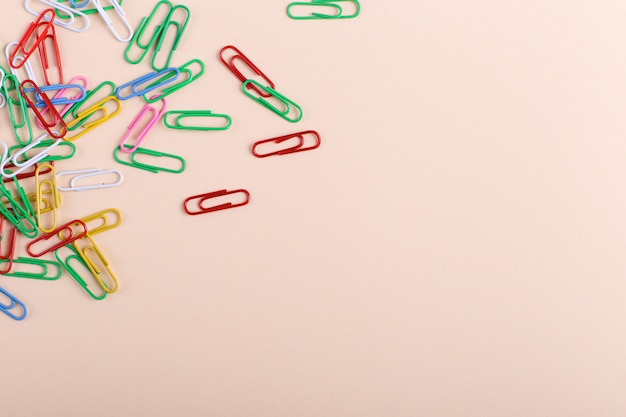Multicolored paper clips  on coral