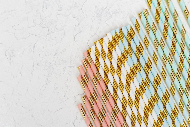 Multicolored paper drink straws with striped pattern gold colored