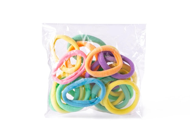 Multicolored  pastel elastic hair 
in transparent packaging  on white isolated background.