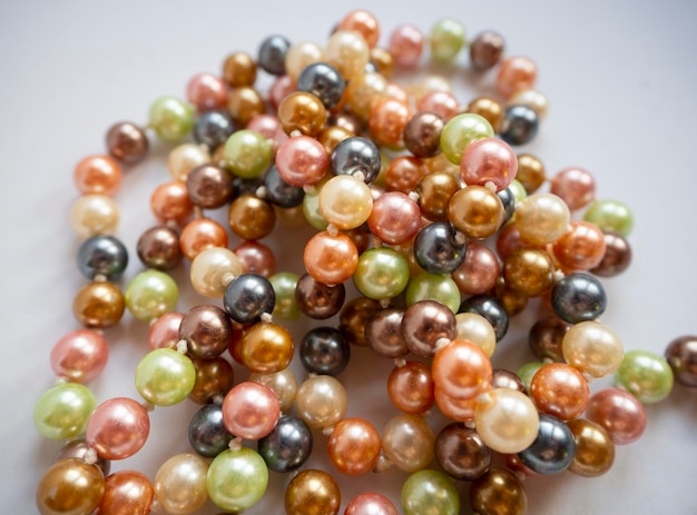 Multicolored pearl beads closeup on a white background