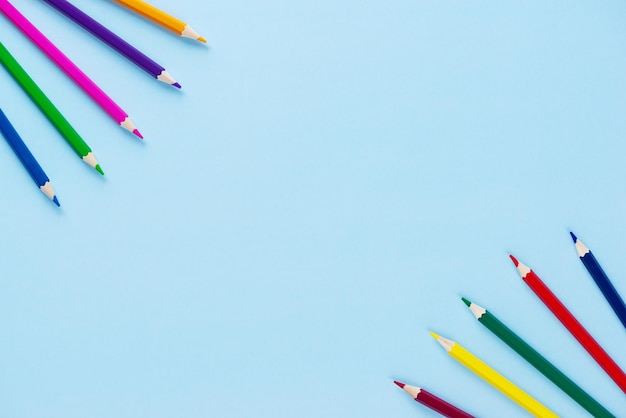 Multicolored pencils on a blue background Horizontal orientation copy space