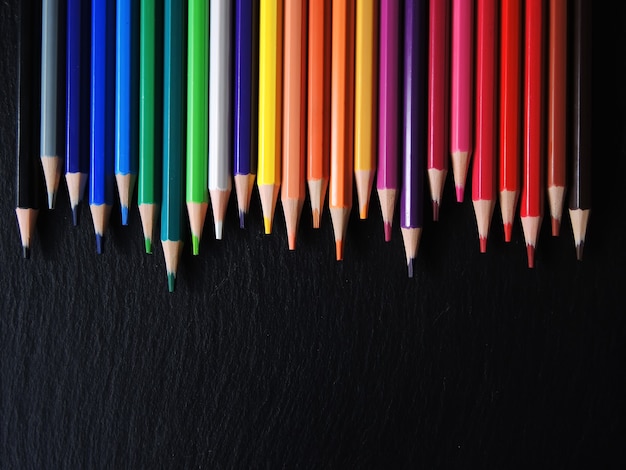 Multicolored pencils isolated on black background.Close up.