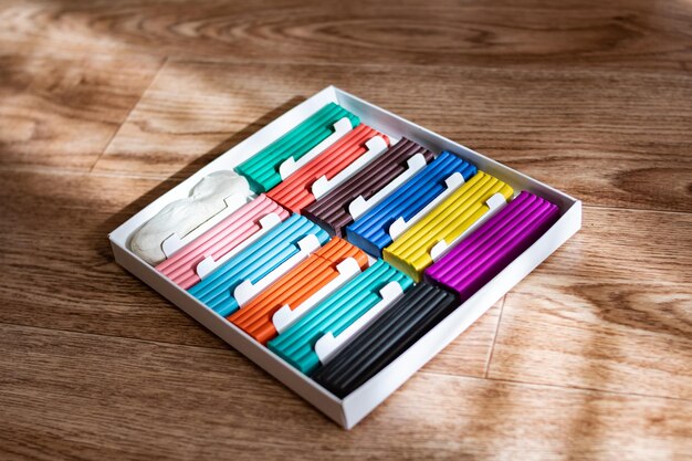 Multicolored plasticine on a wooden table closeup