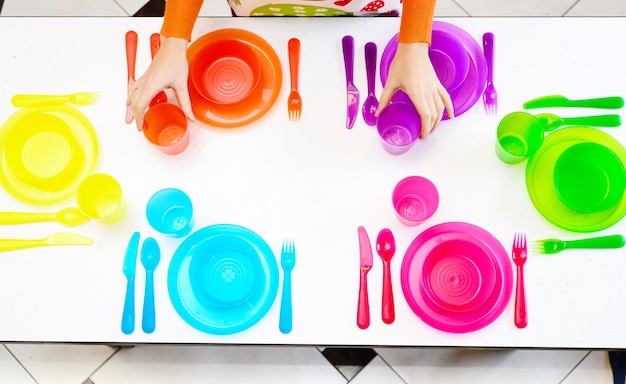 Multicolored plate fork spoon cup on the table top view