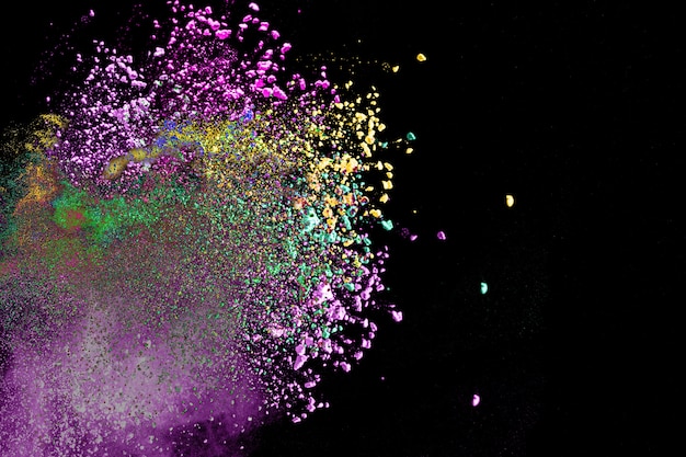 Multicolored powder explosion on black background.