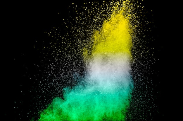 Multicolored powder explosion on black background.