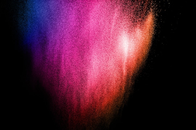 Multicolored powder explosion on black background.