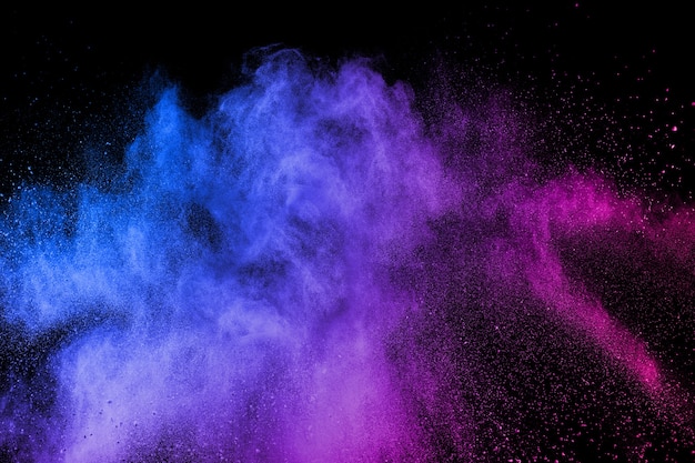 Photo multicolored powder explosion on black background.