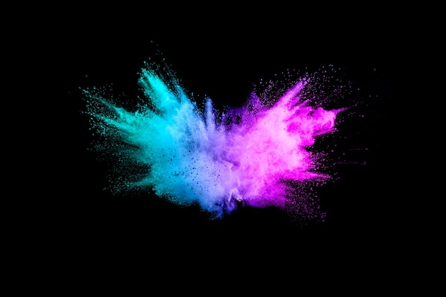 Multicolored powder explosion on black background.