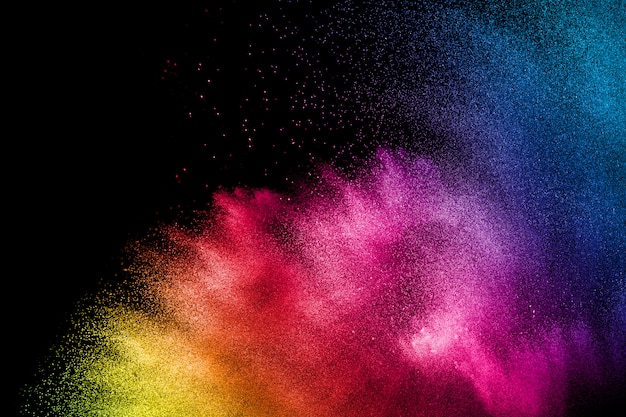 Multicolored powder explosion on black background.