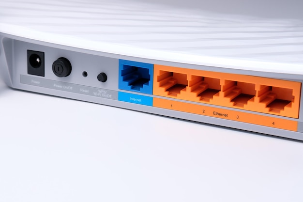 Multicolored RJ45 connectors and buttons on the back of the WiFi router for organizing a home Internet network