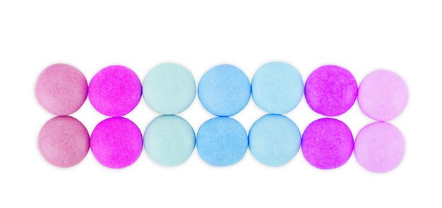 Multicolored round candies on a white background