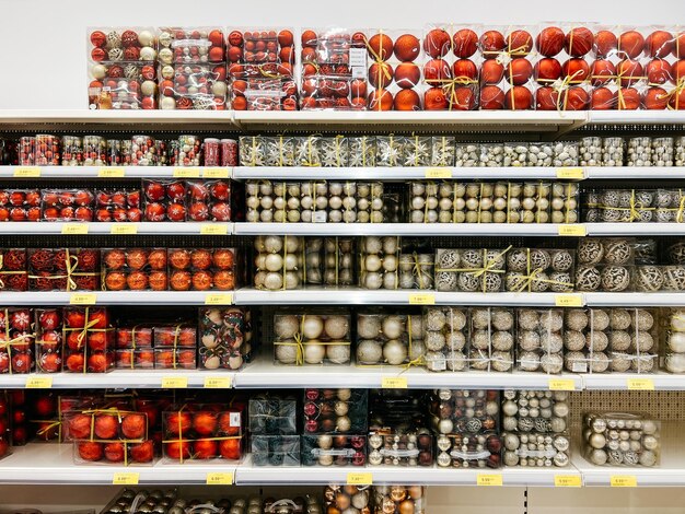 Photo multicolored sets of balls in boxes are on the shelves in the supermarket