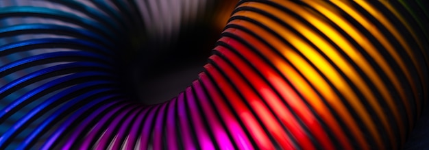 Multicolored slinky toy spiral, panoramic image