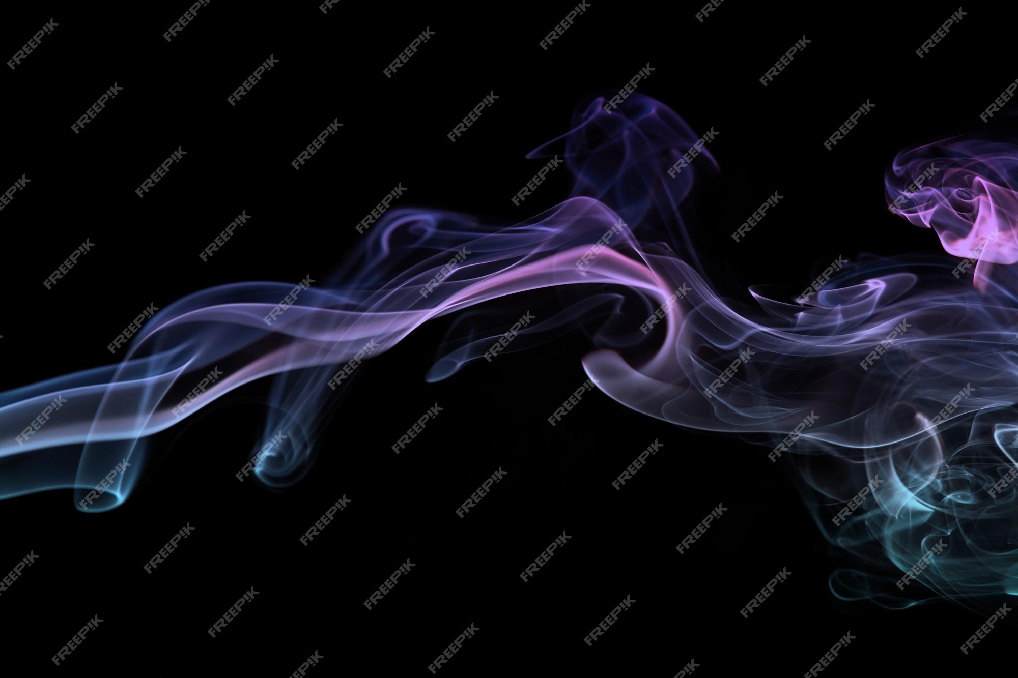 Smoke from Ultrasonic Aroma Diffuser and colorful light on black background.  Color Steam moving in dark. Real Artificial smoke in Colorful light on  black. Represent mood and tone feeling of Cyber punk