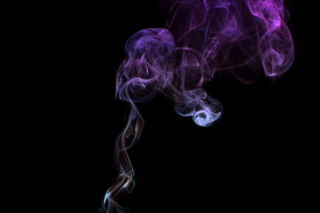 Multicolored smoke for aromatherapy relaxation on black background beautiful swirled puffs of smoke