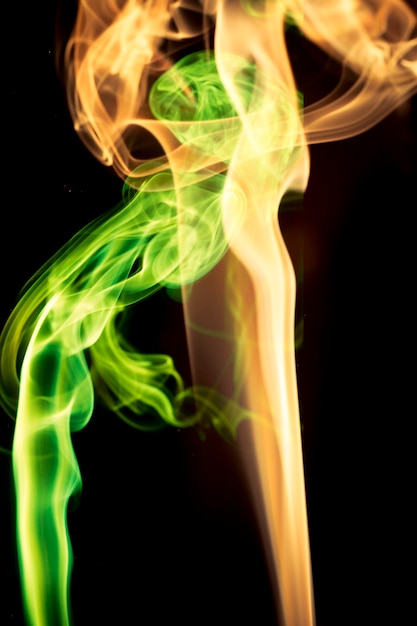 Multicolored smoke on black background.