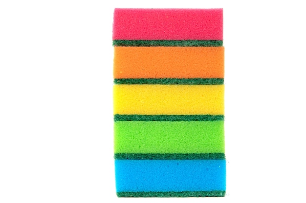 Multicolored sponges for washing dishes in a stack on a white background