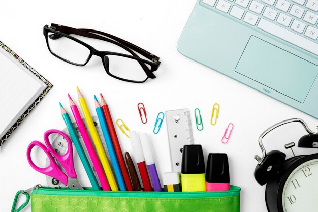 Multicolored stationery supplies with a laptop