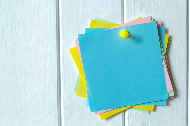 Multicolored sticky empty notes on the bulletin board. 