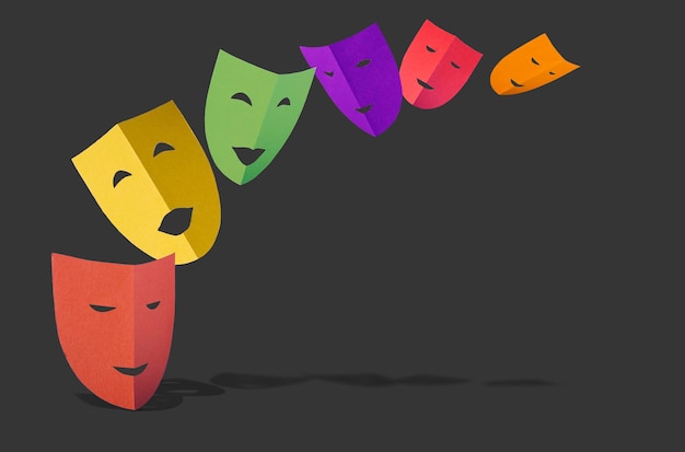 Multicolored theatrical paper masks with shadow flying on a black background copy space