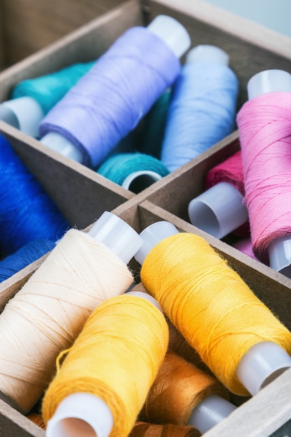 Multicolored threads in wooden box