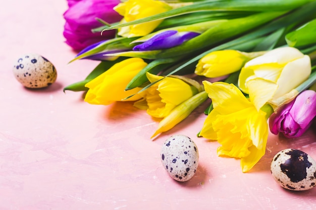 Multicolored tulips and daffodils flowers. Happy Easter greeting