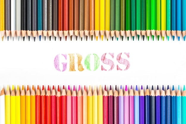 Multicolored wooden sticks Wooden colouring pencils and Gross on white background