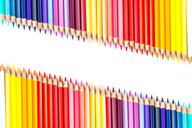 Multicolored wooden sticks Wooden colouring pencils on white background