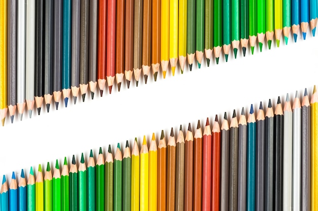Multicolored wooden sticks wooden colouring pencils on white\
background
